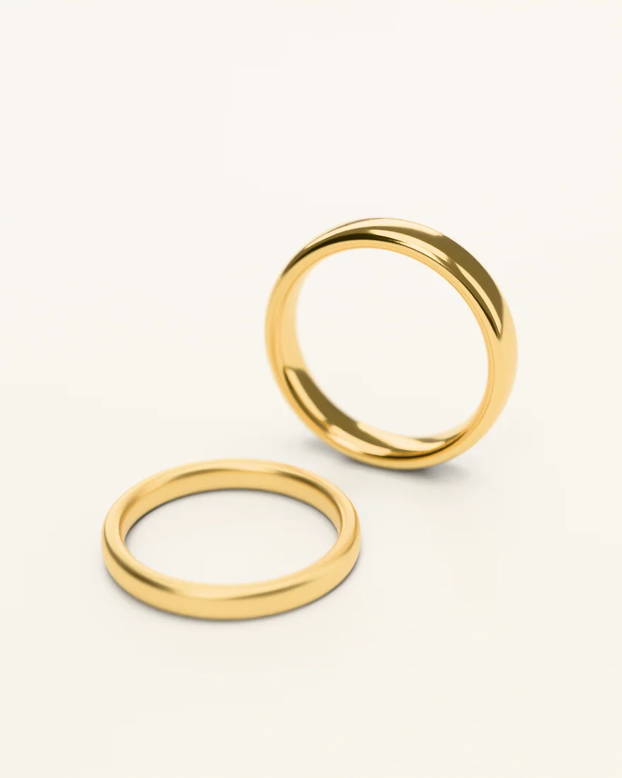 Two plain gold bands, one standing and one lying flat